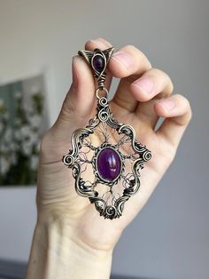 Immerse yourself in the allure of this exquisite handcrafted pendant, where the magic of wire wrapping meets the mystique of amethyst gemstones. This one-of-a-kind piece embodies the essence of Gothic Victorian elegance with a touch of fantasy. 🔮 Product Details: - Handcrafted with Love: Each pendant is meticulously wire-wrapped by hand, ensuring a unique piece of wearable art. - Premium Materials: Fashioned from high-quality antique brass wire for durability and timeless appeal. - Gemstone Mag Artisan Purple Wire Wrapped Jewelry, Artisan Amethyst Wire Wrapped Jewelry, Purple Hand Forged Spiritual Jewelry, Hand Forged Purple Spiritual Jewelry, Artisan Hand Forged Amethyst Jewelry, Artisan Amethyst Wire Wrapped Necklaces, Unique Purple Wire Wrapped Jewelry, Unique Wire Wrapped Amethyst Necklaces, Unique Amethyst Wire Wrapped Necklaces