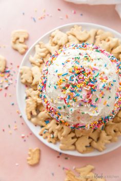 a white plate topped with lots of cookies and sprinkles