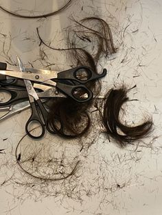 scissors are laying on top of some hair