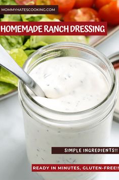 a jar filled with ranch dressing next to a plate of vegetables and salad on a table