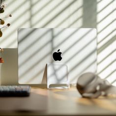 an apple computer sitting on top of a wooden desk