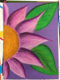 a drawing of a pink flower with green leaves on purple paper next to crayons