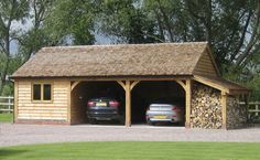 two cars are parked in front of a wooden garage with logs stacked on the roof