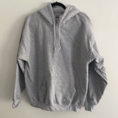 Gray Hoodie In Brand New Condition Never Worn Basic Hooded Winter Sweater, Basic Winter Hooded Sweater, Basic Winter Hoodie Sweater, Basic Long Sleeve Sweatshirt With Adjustable Hood, Plain Hoodie For Winter, Plain Hoodie Top For Winter, Casual Plain Hoodie For Winter, Basic Hooded Tops For Winter, Athletic Heather Long Sleeve Sweatshirt With Drawstring Hood