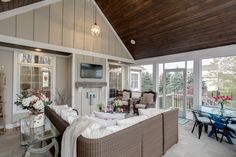 a living room filled with furniture and a flat screen tv mounted to the side of a wall