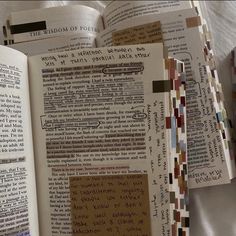 an open book with many different types of paper on it's pages and the words written in them