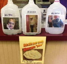 three plastic jugs with pictures on them sitting on a shelf