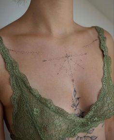 a close up of a woman's bra with tattoos on her chest and shoulder