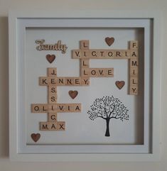 scrabble art with family tree and hearts in white shadow box frame on wall