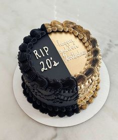 a black and gold birthday cake with the words rip 20th on it's side