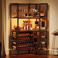 a wine rack filled with lots of bottles and glasses on top of a hard wood floor