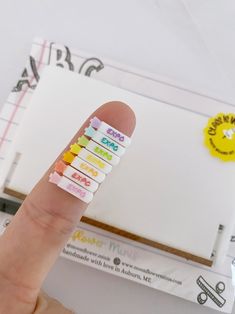 a person's finger pointing at some sticky notes