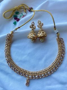 Elevate your bridal ensemble with our stunning Gold Indian Choker Set, meticulously designed to make you shine on your special day. This exquisite choker set is a flawless blend of tradition and contemporary elegance, handcrafted with love and attention to detail. Material: Gold Plated Brass Styling Tips: This choker set complements traditional Indian attire like lehengas or sarees. Opt for colors that match or contrast with your outfit to create a stunning look. Ideal gift: Gift this set to a friend or treat yourself to a captivating piece that will become a cherished heirloom. Care Instructions: Clean with dry cloth. Keep in an airtight container or pouch when not in use. Avoid harsh chemicals or heat such as perfume, deo, hairspray, etc. Gold Kundan Necklace With Matching Earrings For Wedding, Elegant Jewelry Sets For Marriage And Festive Occasions, Elegant Festive Jewelry Sets For Marriage, Elegant Kundan Bridal Earrings, Elegant Kundan Bridal Earrings For Marriage, White Kundan Necklace With Matching Earrings For Wedding, Traditional Bridal Necklace With Matching Earrings For Anniversary, Round Bridal Necklace With Matching Earrings For Anniversary, Bridal Necklace With Matching Earrings For Wedding