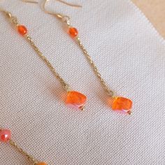 Gorgeous orange  beaded drop earrings. These uniqe, one-of-a-kind  earrings are made of quality Czech glass beads and gold plated stainless steel components. Earring hooks are made of hypoallergenic gold plated stainless steel.  Dimensions:                                              total length incl. hooks: 6.5 cm(2.6 in) These elegant earrings would make a lovely gift.  They will arrive wrapped in tissue paper in a padded envelope.  Matching bracelet with stud earrings is available as seen o Orange Faceted Beads Jewelry For Gift, Orange Faceted Beads For Jewelry Making, Orange Faceted Beads For Crafting, Orange Teardrop Beaded Earrings For Gift, Orange Teardrop Beaded Earrings As Gift, Handmade Orange Long Drop Earrings, Orange Faceted Beads Dangle Earrings, Orange Teardrop Beaded Earrings With Ear Wire, Orange Round Bead Earrings