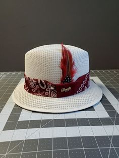 "Frank Garcia Hat White traditional derby fedora lowrider hat made of 100% woven finest cotton string comes with burgundy bandana band, 2\" brim. Also comes with a silk inside liner, real rooster feather, pearl pin." Adjustable Fitted Hat With Short Brim For Summer, Mens Dress Hats, Frank Garcia, Rooster Feathers, Pearl Pin, Cotton String, Dress Hats, Lowrider, Hat Making