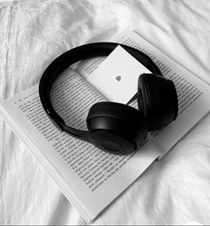 headphones resting on top of an open book