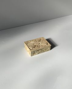 a wooden box sitting on top of a white table