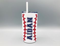 a plastic cup with a straw in the shape of a baseball and name on it