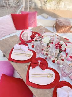 a table set for valentine's day with red and white decor