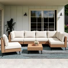 an outdoor living room with wicker furniture