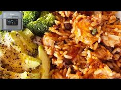 a plate with rice, broccoli and other food items on it next to a camera