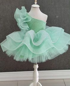 Make your little one's special day unforgettable with our One Shoulder Mint Green Tutu Dress! Perfect for birthdays, parties, and other special occasions, this elegant dress features a beautiful one-shoulder design and a stunning mint green tutu with glittery accents. Features: Charming One Shoulder Design: Adds a touch of sophistication and uniqueness to the dress. Glittery Mint Green Tutu: Sparkles and shines, making your little girl the center of attention. Soft and Comfortable Fabric: Ensure Mint Green Dresses, Toddler Pageant Dresses, Dress Mint Green, Kids Party Wear Dresses, Green Tutu, Baby Birthday Dress, Kids Party Wear, Toddler Party Dress, Party Frocks