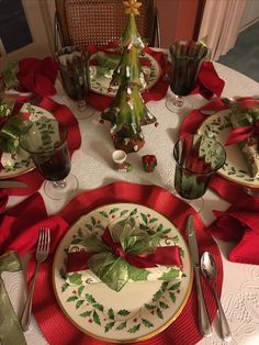 a table set for christmas with plates and silverware