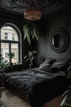 a bed sitting in a bedroom next to a window filled with potted plants and greenery