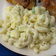 a plate with macaroni and chicken on it