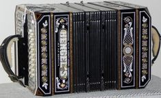 an old accordion sitting on top of a table