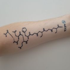 a person with a tattoo on their arm that has the chemical structure of caffe