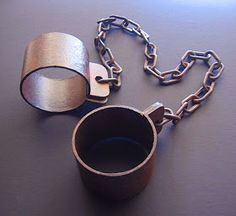 a metal cup and chain on a table