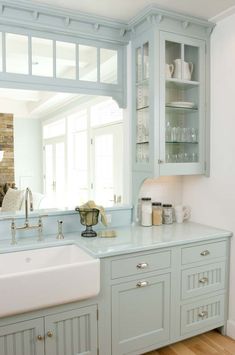 a kitchen with blue cabinets and white counter tops