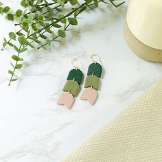 Introducing our exquisite green floral clay earrings, the perfect accessory to complement your wedding day ensemble with timeless elegance. Crafted with utmost care and attention to detail, these stunning earrings feature a soft, neutral hue that effortlessly blends with any wedding theme and attire. The beige clay showcases a subtle, organic texture, adding a touch of natural charm to your overall look. The delicate design exudes sophistication, making these earrings a delightful choice for bri Green Polymer Clay Flower Drop Earrings, Minimalist Green Polymer Clay Earrings, Green Flower Earrings With Ear Wire For Wedding, Green Flower Earrings For Wedding With Ear Wire, Elegant Green Polymer Clay Jewelry, Delicate Bridal Earrings, Green Flower Earrings, Floral Clay Earrings, Clay Flower Earrings