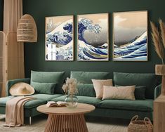 a living room with green walls and paintings on the wall, including an ocean wave