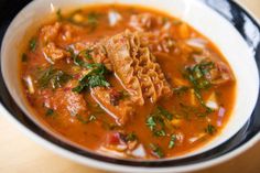 a white bowl filled with soup on top of a table