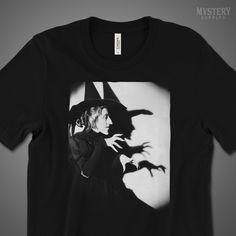 a black t - shirt with an image of a woman in a witches hat on it