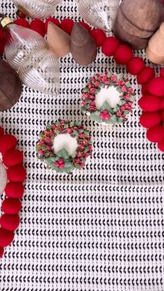 some red and white decorations are laying on a table with other items in the background