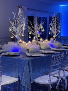 the table is set with candles and centerpieces for an elegant winter wedding reception