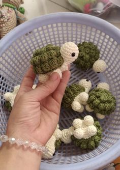 someone is holding some tiny crocheted animals