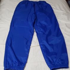 Windbreaker Joggers With Elastic Ankles. Fabric Is On The Stiffer Side, They Make A Little Noise. The Polyurethane Finish Adds A Cool Looking Shine/Silk Look To Them. The Tag Does Not State Gender, So I Listed The Exact Measurements Below. Color: Royal Blue. Outside Shell: 100% Nylon With 600mm Pu Coating Inside Liner: 100% Cotton Top With 100% Nylon Ankles. Pockets: 2 Side, 1 Back Zip Pocket. Condition: Nwt Flaws: Missing Drawstring At The Waistband. Exact Measurements. Size Tag: S Waistband (R Sporty Nylon Pull-on Bottoms, Sporty Nylon Bottoms With Pull-on Style, Blue Nylon Sports Bottoms, Sports Blue Nylon Bottoms, Blue Nylon Sportswear Bottoms, Blue Stretch Pants For Outdoor, Sporty Blue Nylon Pants, Blue Nylon Long Pants, Sporty Blue Bottoms For Outdoor