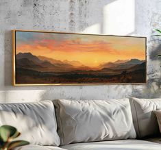 a painting hanging on the wall above a couch