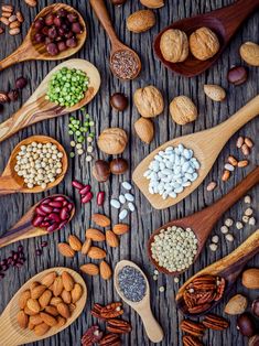 nuts and seeds in wooden spoons on a table