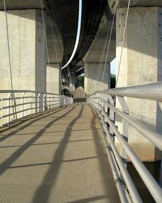 the bridge is very tall and has metal railings