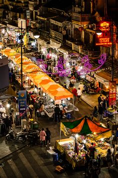 an aerial view of a street market at night