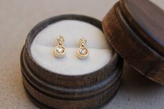 Lovely minimal 14k solid yellow gold .09 ctw diamond studs, perfect sparkly everyday look! * Handmade in the USA. * Gold KT: 14K solid yellow gold. * Primary gemstone: : 2 mm round diamond (.06 ctw). * Secondary Gemstone: 1.5 round diamond (.03 ctw). * Earring Closure: Screw Back. * Earring Style: Drop Studs. * Earring length: 11 mm approximately. * Setting Type: Prong Setting. * Additional Notes: This item can be customized. * Ready to ship. FREE SHIPPING! Gold Diamond Earrings With Bezel Setting For Wedding, 14k Gold Diamond Earrings With Bezel Setting For Wedding, 14k Gold Rose Cut Diamond Earrings For Gift, 14k Gold Bezel Set Diamond Earrings For Wedding, Dainty Gold Diamond Earrings With Single Cut, Timeless Rose Cut Diamond Earrings As Gift, 14k Gold Diamond Earrings With Accents For Gift, 14k Gold Diamond Earrings With Diamond Accents As Gift, 14k Gold Diamond Earrings With Diamond Accents