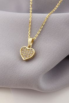 Adorn yourself with elegance and love with our enchanting Gold Heart Pendant Necklace. This dazzling piece features intricate details and sparkling stones that capture the essence of romance and charm. The heart-shaped pendant exudes a sense of sentiment and beauty, making it a perfect accessory to express your affection for someone special. Whether it's a gift for yourself or a loved one, this necklace is an ideal choice to celebrate love and emotions. Embrace the magic of this pendant as it shines brightly and gracefully around your neck, adding a touch of sophistication to any outfit. Let this stunning necklace be a symbol of love, a thoughtful gesture for Valentine's Day or any occasion that calls for a meaningful and stylish jewelry piece. Elegant Double Heart Cubic Zirconia Necklace, Sparkling Stones Heart Pendant For Wedding, Wedding Necklace With Heart Charm And Cubic Zirconia, Sparkling Stone Heart Pendant For Wedding, Elegant Cubic Zirconia Heart Charm Necklace, Sparkling Heart Pendant For Wedding, Elegant Cubic Zirconia Heart Necklace, Wedding Cubic Zirconia Necklace With Heart Charm, Heart-shaped Cubic Zirconia Wedding Necklace