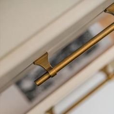 a close up view of the handles on a door handle and curtain rod in a room