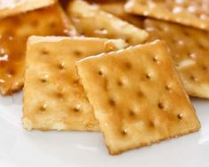 some crackers on a white plate with sauce