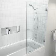 a white bathroom with a glass shower door